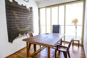 a dining room with a wooden table and chairs at Dev1villa in Lonavala