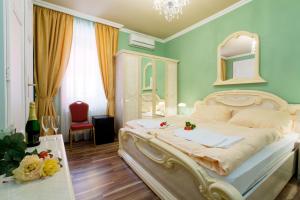 
a bedroom with a large bed and a large window at Hotel Bow Garden in Komárno

