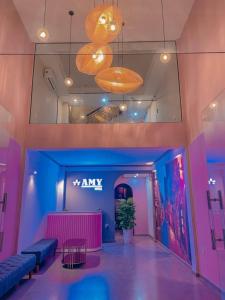 a lobby of a store with blue and pink walls at Amy Hotel in Can Tho