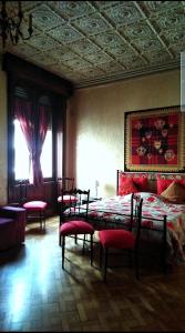 sypialnia z łóżkiem z czerwonymi poduszkami w obiekcie B&B Amarantha Gothica Genoa w Genui