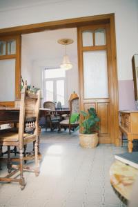 a room with a table and chairs and a dining room at B&B Herenhuis1919 in Lo-Reninge