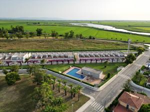 an aerial view of a building with a pool and palm trees at Birds&Nature in L'Eucaliptus
