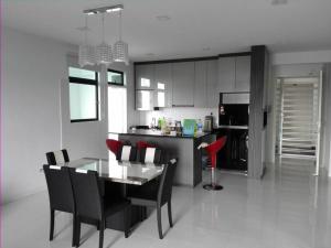 a kitchen and dining room with a table and chairs at Skyloft Premium Suites 8 pax in Johor Bahru