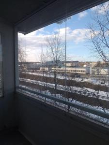 a window with a view of a snow covered field at Top floor flat w. sauna/balcony/free parking in Rovaniemi