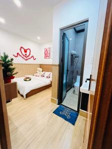 a bedroom with a bed and a glass door with a mirror at An Vy Hotel in Da Lat