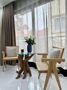 a room with a table and two chairs and a window at Dahlia Homestay Tay Ho in Hanoi