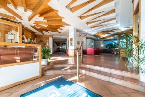 a lobby of a building with wooden ceilings at Hotel Tubris Garnì Campo Tures in Campo Tures