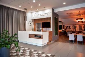 a lobby of a restaurant with a counter and a table at Hotel Maraton in Szamotuły