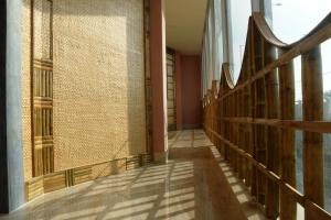 a hallway of a building with a tile wall at Hotel Himalaya in Agartala