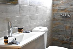 a bathroom with a sink and a toilet and a shower at Zefyros in Samothraki +20 photos
