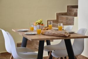 a wooden table with glasses of orange juice at Zefyros in Samothraki