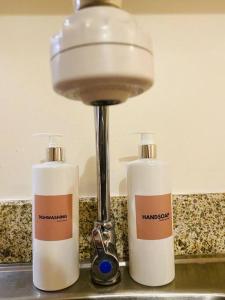 two bottles ofodorizers on a counter next to a light at Modern Living by The Celandine DMCI in Balintawak in Manila