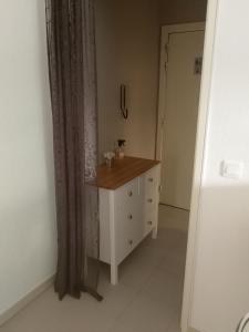 a room with a dresser and a door with a curtain at Lovely Studio & Garden - près des plages Cagnes-sur-Mer in Cagnes-sur-Mer