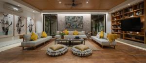 a living room with couches and a flat screen tv at Villa Pantai Indah - 100m to Pererenan Beach in Canggu