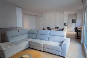 a living room with a couch and a table at Oostduinkerke Res Henri IV in Oostduinkerke