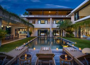 an image of a house with a swimming pool at Villa Pantai Indah - 100m to Pererenan Beach in Canggu