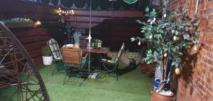 a patio with a table and chairs and a plant at La Paula in Altenmedingen