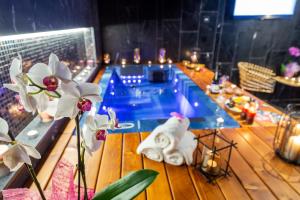 a table with white flowers and a swimming pool at Perelik Hotel in Pamporovo