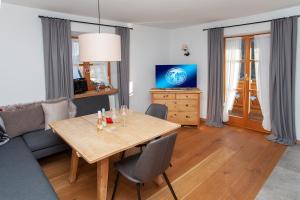 - un salon avec une table et un canapé dans l'établissement das Alpen Natur Idyll, à Grainau