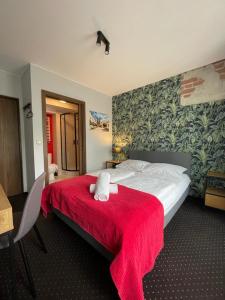 a bedroom with a large bed with a red blanket at Boogie Deluxe Old Town in Wrocław