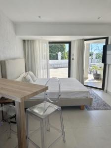 a bedroom with a bed and a table and a table at Studio H GrandBay Sea-View in Grand-Baie