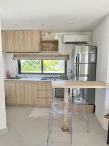 a kitchen with a counter and a refrigerator at Studio H GrandBay Sea-View in Grand-Baie