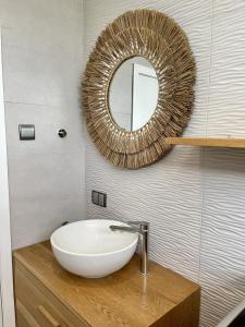 a bathroom with a white sink and a mirror at Studio H GrandBay Sea-View in Grand-Baie