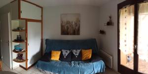 a blue couch in a living room with a mirror at studio Morillon village in Morillon +11 photos