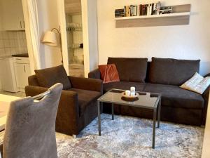 a living room with a couch and a table at Duene 43 in Wangerooge
