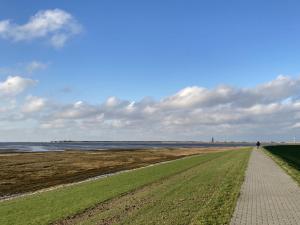 a walkway leading down to the water on a beach at Duene 43 in Wangerooge