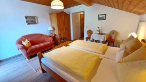 a living room with a bed and a couch at Gästehaus Fellner in Aschau im Chiemgau