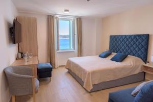 a bedroom with a bed and a large window at Šangulin Palace M in Biograd na Moru