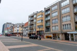 a city street with buildings and a car on the road at Euro V 0301 in Middelkerke