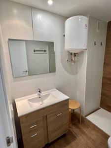 a bathroom with a sink and a mirror at Apartamentos Centro Benicasim in Benicàssim