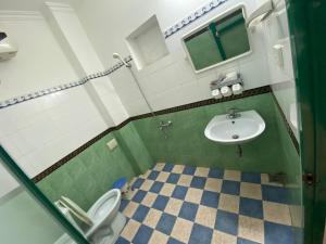 a bathroom with a toilet and a sink at Alex Hostel in Ha Long +24 photos