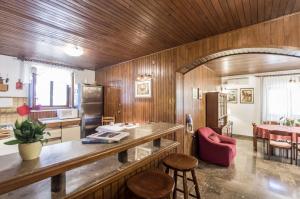 a kitchen with wooden walls and a table and chairs at House Vinka in Selca
