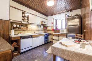 a kitchen with white appliances and a table in it at House Vinka in Selca