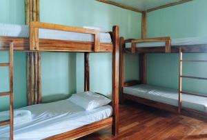 a room with three bunk beds in a house at Casa Nena Hotel & Resort Iloilo by RedDoorz in Iloilo City