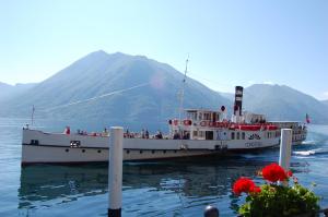 a boat in the water with people on it at Seven Park Hotel Lake Como - Adults Only in Colico