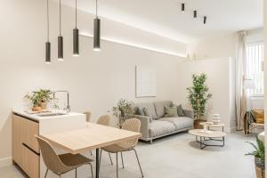 a living room with a couch and a table at Apartamentos Pamplona by Clabao in Pamplona