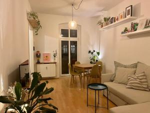 a living room with a couch and a table at 1 room apartment in Friedrichshain in Berlin