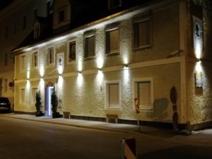 a building with lights on the side of it at night at Appartment Graz Zentrum in Graz