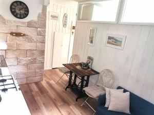 a dining room with a table and chairs and a clock at Studio Milla in Split