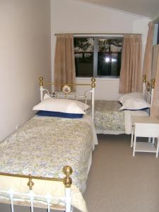 Katil atau katil-katil dalam bilik di Memory Lane Country Cottage