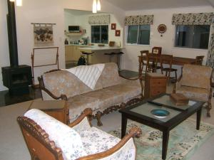 a living room with a couch and a table at Memory Lane Country Cottage in Cambridge