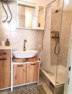 a bathroom with a sink and a shower at Studio Milla in Split