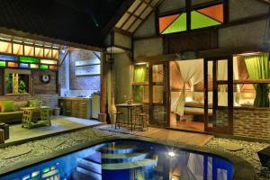 a room with a swimming pool and a bedroom at Villas SAMALAMA Gili Trawangan in Gili Trawangan