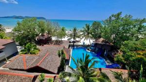 an aerial view of a resort with a swimming pool and the beach at Malibest Resort in Pantai Cenang