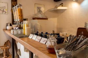 a kitchen counter with utensils on a counter top at Gästehaus Kaltenbach in Staufen im Breisgau