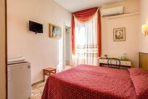 a bedroom with a red bed and a window at Giovy in Rome